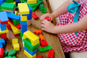 Child plays with colorful blocks
