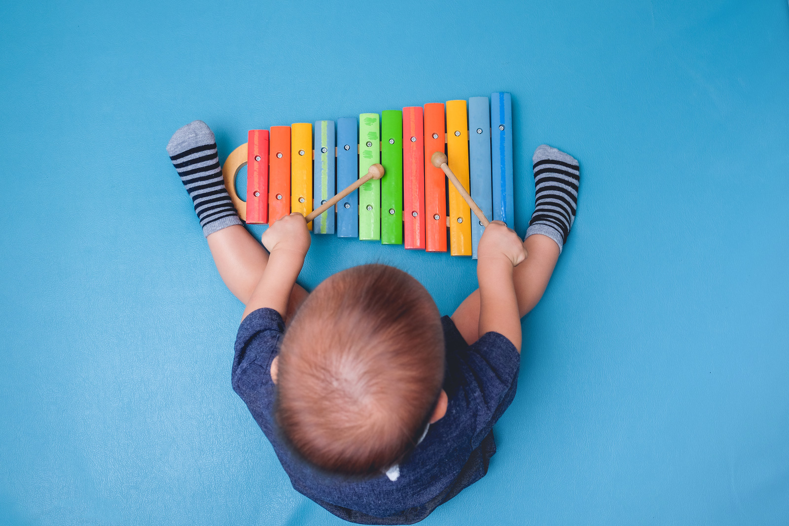 Child playing colorful xylophone