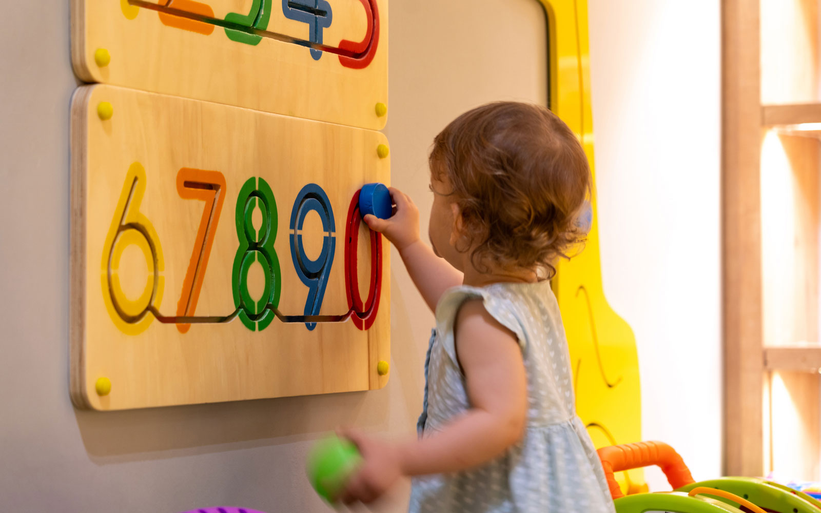 Little girl learning numbers in childcare setting