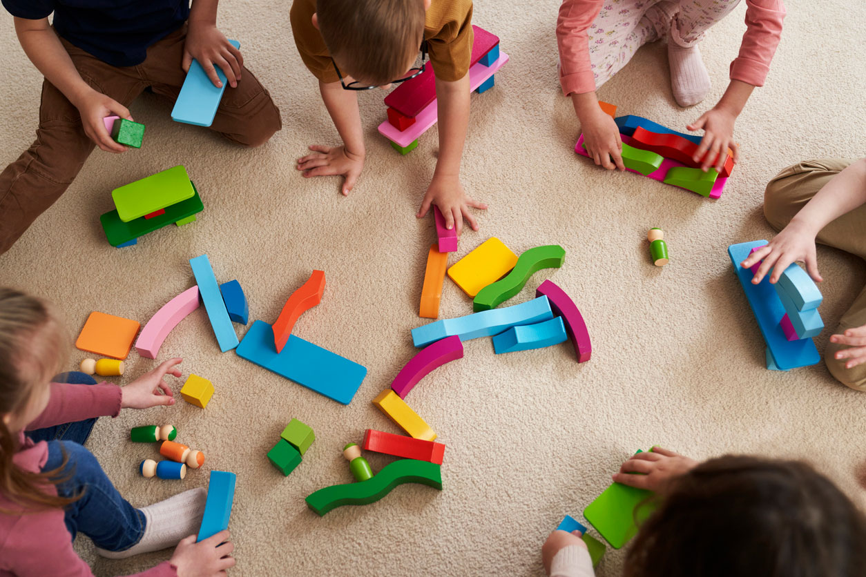 Children playing with blocks on the floor