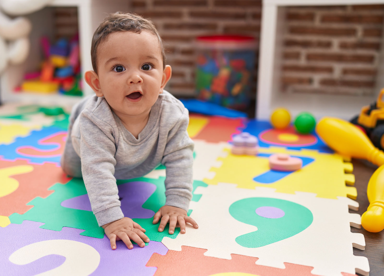 Baby crawling on foam mat