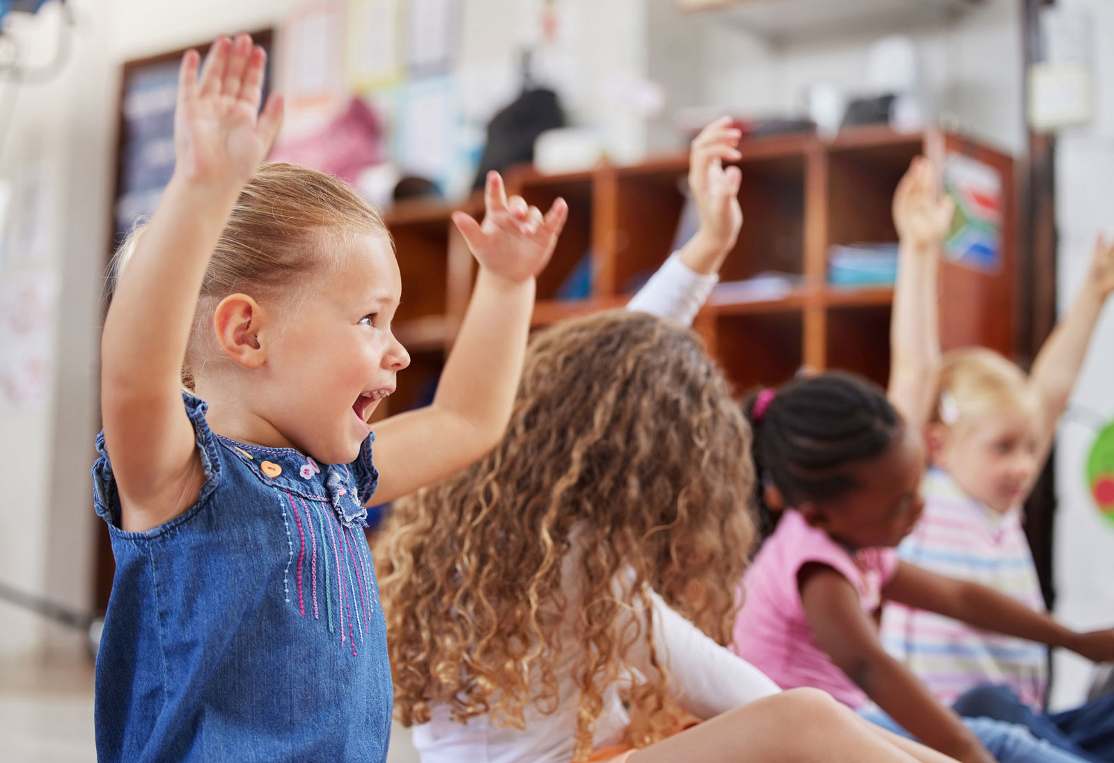 Children doing hand motions during daycare music time