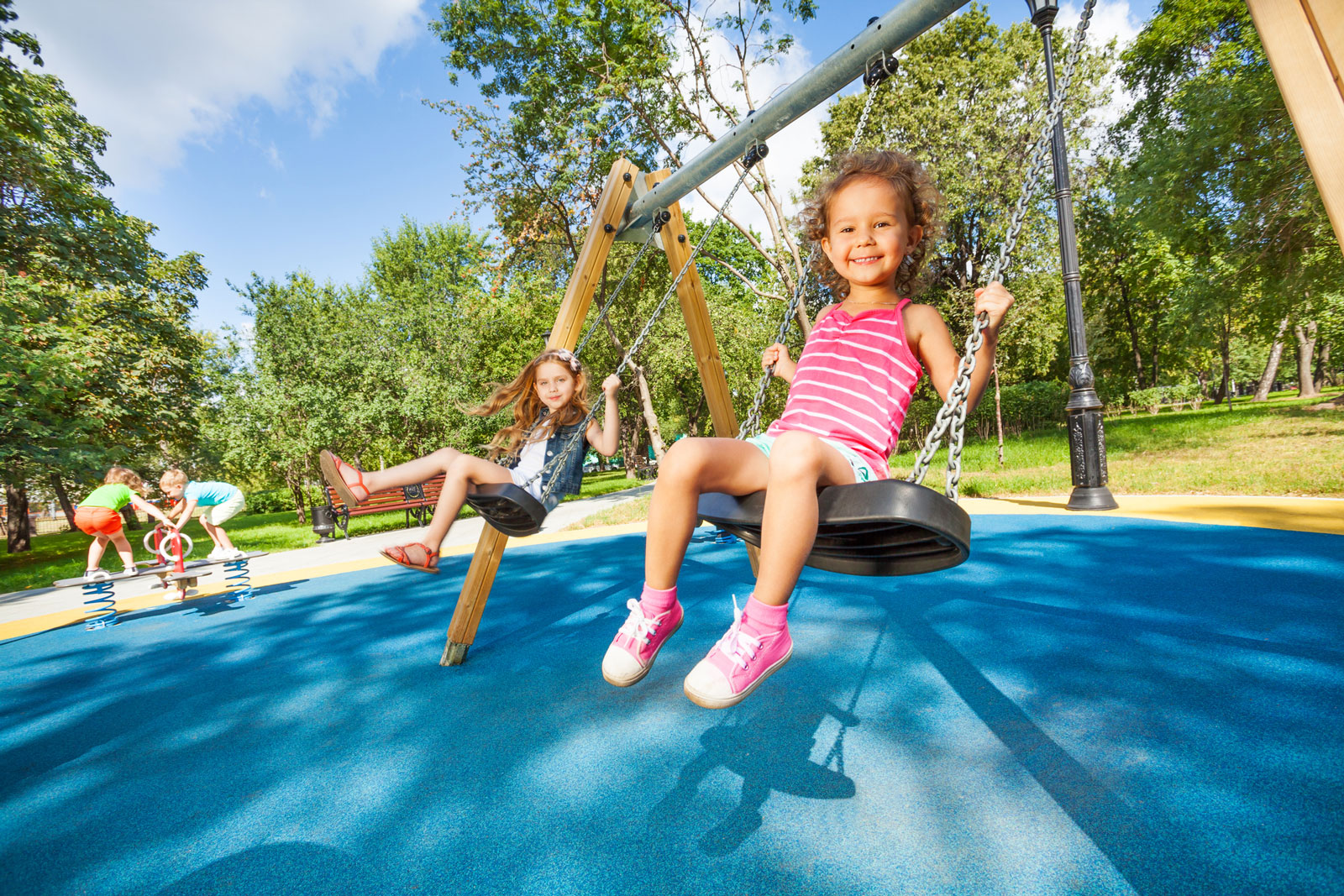 Preschoolers swing at a park