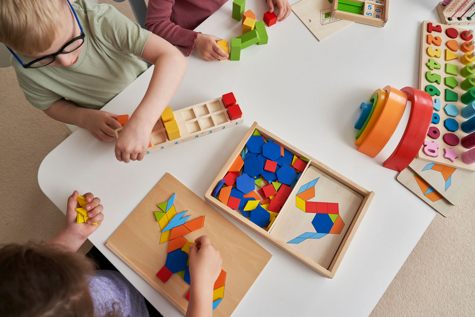 children playing with puzzles and blocks at daycare